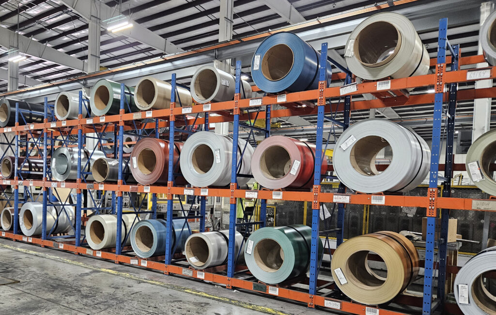 Metal coils in racks at manufacturing facility