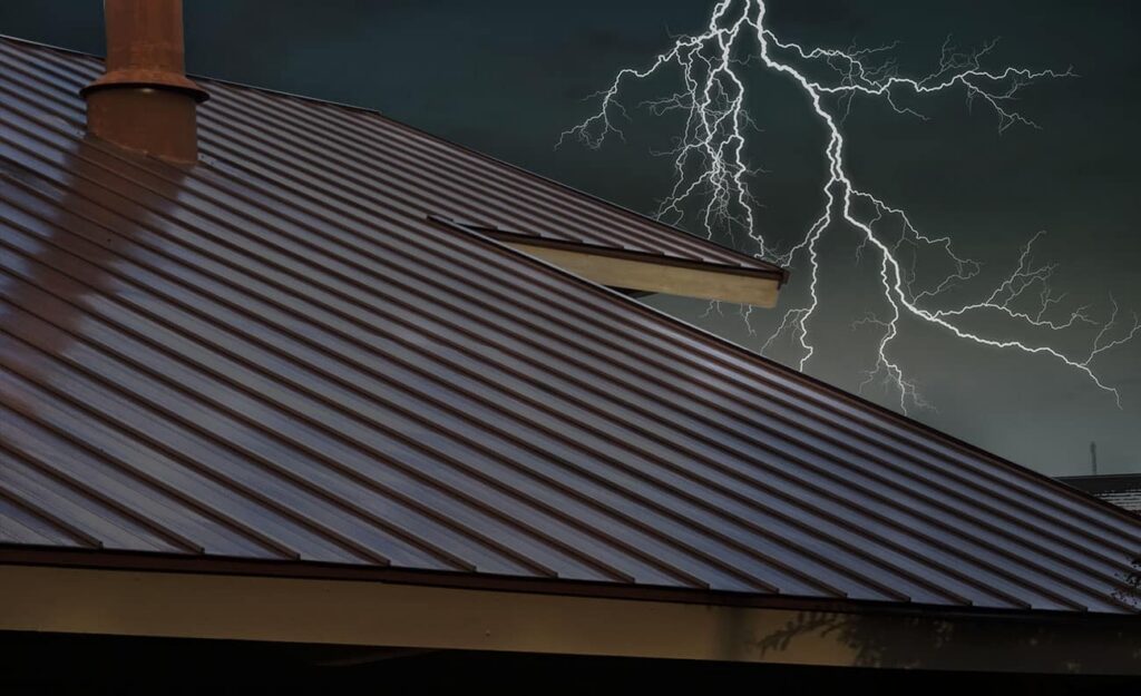 Storm with lightning shown over a metal roof on a home